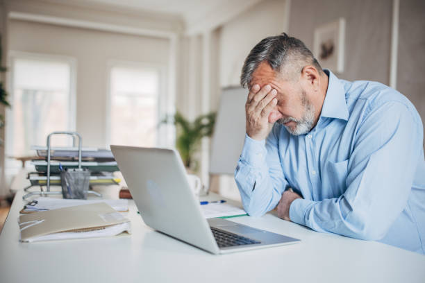 istock Senior male manager is sitting in the office, he is worried about work 1472263243