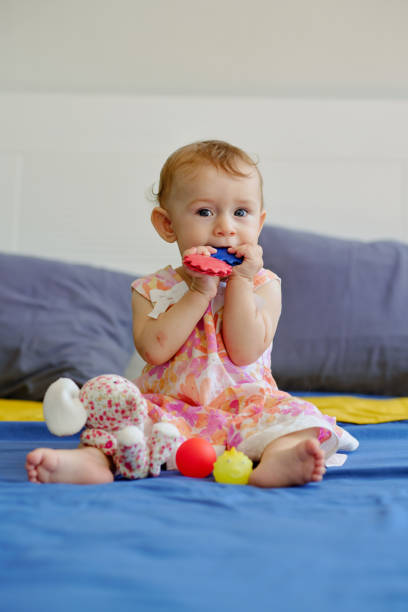 istock Girl Sucking Plastic Toys 1472264431