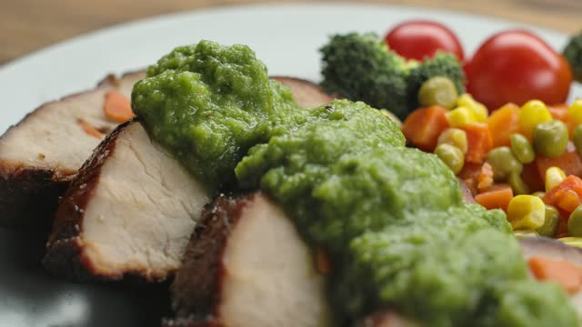 Green sauce is poured over mouth-watering pieces of boiled pork