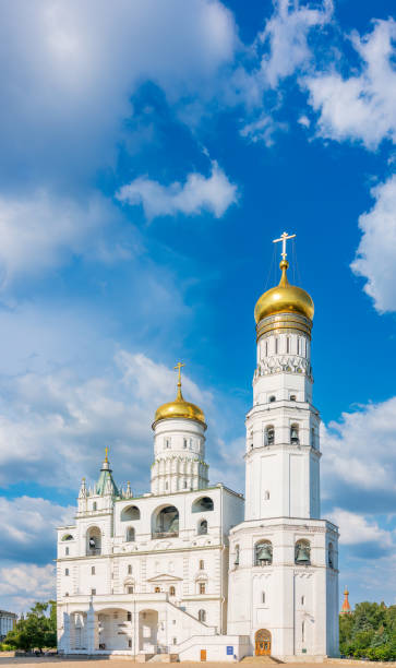 istock Ivan the Great Bell Tower, with Assumption Belfry on the right in Moscow Kremlin. Blue sky background with sunbeams 1472265082