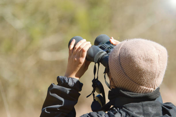 istock Outdoor woman, nature explorer with binoculars 1472268887