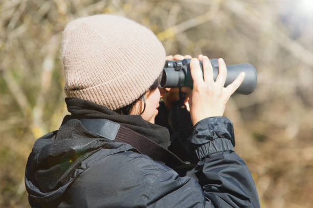 istock Outdoor woman, nature explorer with binoculars 1472268999
