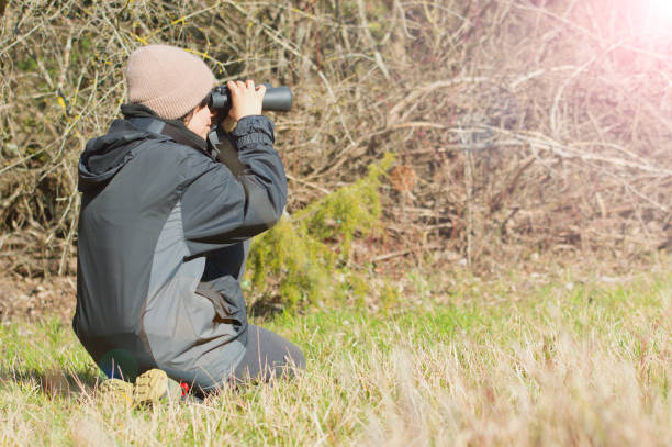 istock Outdoor woman, nature explorer with binoculars 1472269001