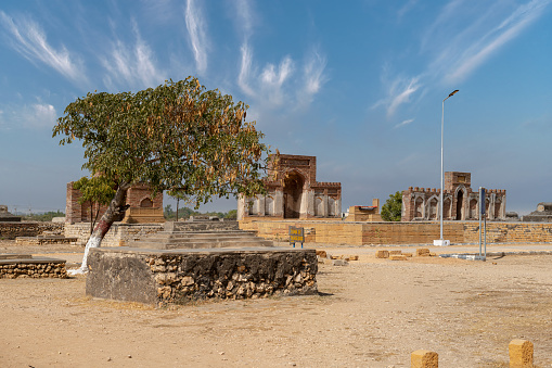 Thatta Sindh, Pakistan - February 04, 2023: Makli Hill Necropolis UNESCO World Heritage Site Picturesque View of a Mausoleum of Isa Khan Tarkhan II on a Sunny Blue Sky Day