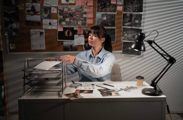 istock Professional detective working on case in office at night. 1472274522