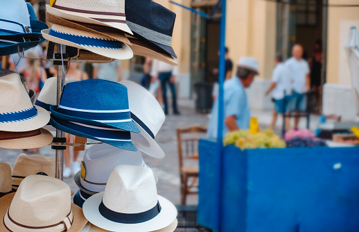 some hats on sale in display on the street in the old town of Athens, in Greece, on a summer day