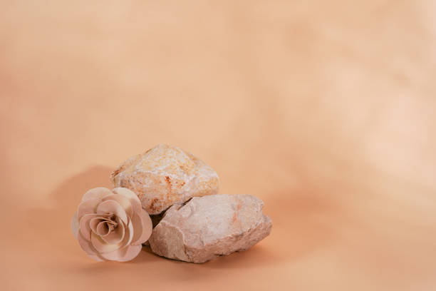 istock Empty stack of stones podium on beige background with flower and shadows. Minimal empty display product presentation scene 1472282427