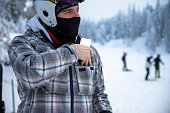 Man put ski pass in to a ski jacket pocket