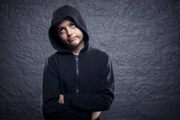 Bored and fed up boy with who cares and whatever apathetic attitude Bored and fed up unhappy boy with who cares and whatever apathetic attitude rolling eyes after conflict of argument with parents rolling eyes irritation displeased facial expression stock pictures, royalty-free photos & images
