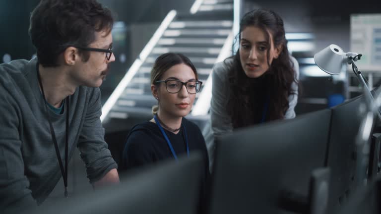 Group of Empowered Multicultural Specialists Working in a Research Center, Using Computer to Collaborate on Advanced Software, Develop Artificial Intelligence Interface and Cloud-Based Blockchain