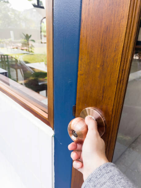 istock Hand on metal door holder 1472288039