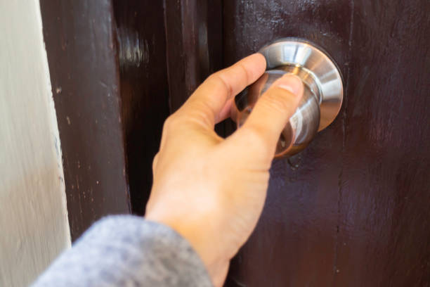 istock Hand on metal door holder 1472288666