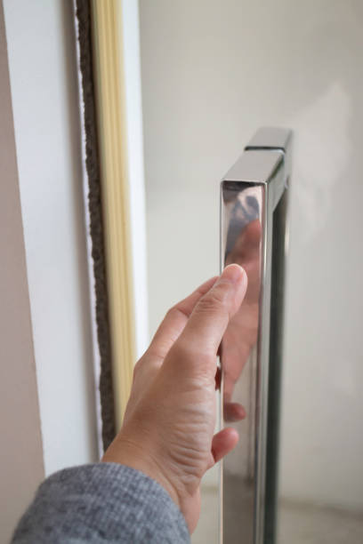 istock Hand on metal door holder 1472288674