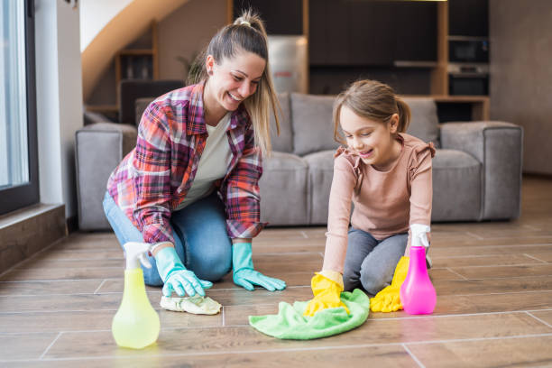 istock Mother and daughter cleaning house 1472288802