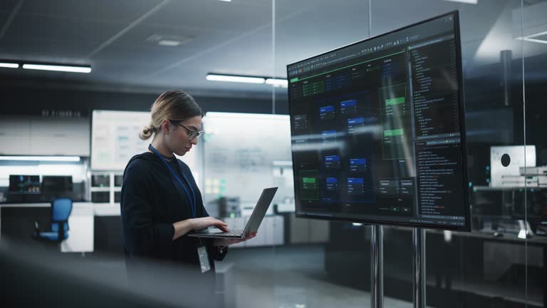 Portrait of a Multiethnic QA Engineer Working on Finding and Fixing Bugs in a Product or Program Software Code Before the Launch. Female Using Laptop Computer, Collaborating with Developers Online
