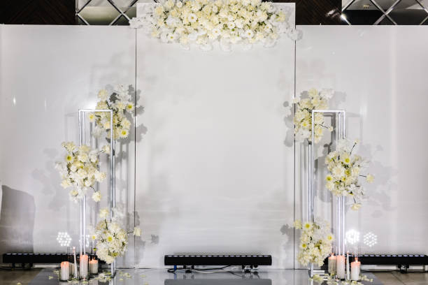 istock Wedding reception for luxury ceremony. Copy space. Celebration baptism concept. Photo-wall, arch place decorated candles and flowers. Trendy decor for birthday party in the banquet area. 1472290803