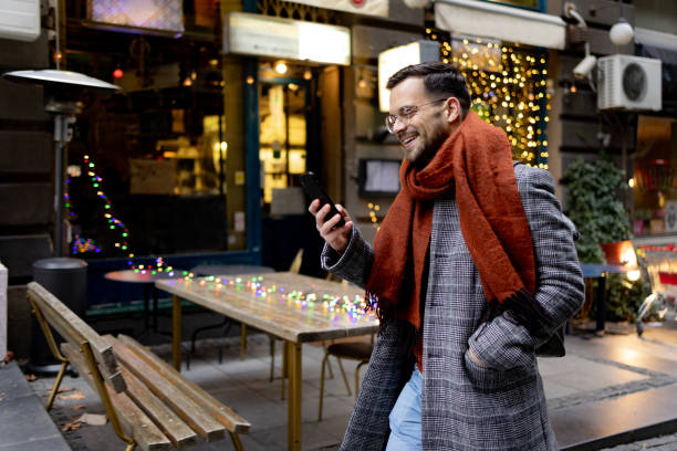 istock Happy man using mobile phone on the move in the city. 1472291007