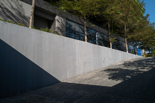 The sun shines on the concrete wall in modern architecture