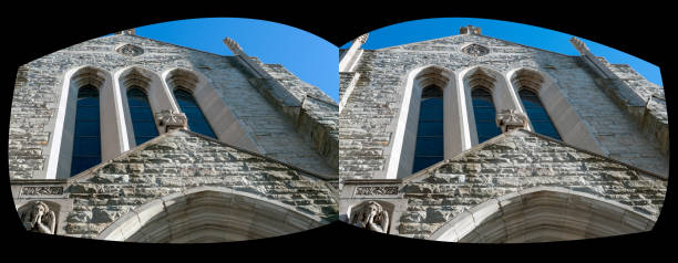 Grey stone church front with windows and crosses.