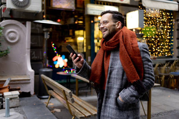 istock Young happy man using smart phone on the move in the city. 1472292751