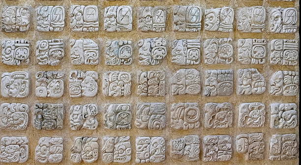 Ancient Mayan hieroglyphics carved in a stone, in Palenque archaeological site, Mexico
