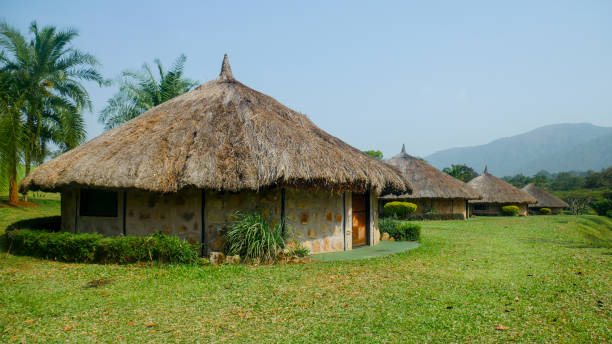 panorama of 4 african huts Panorama on huts in an African village cameroon stock pictures, royalty-free photos & images