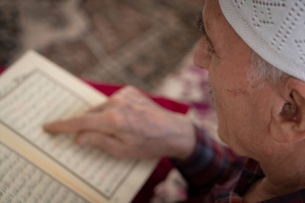 istock Muslim man who is reading Holy Quran 1472295861
