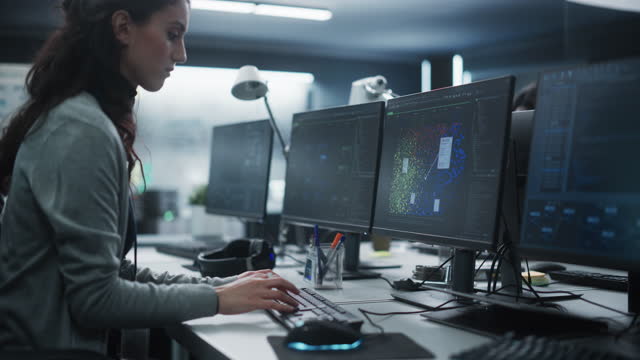Young Female Artificial Intelligence Engineer Working on Computer in a Technological Office. Young Specialist Writing Software Code for an Innovative Big Data Blockchain Project