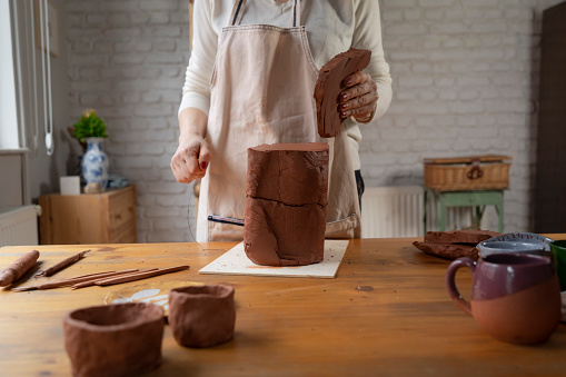 Master class on modeling of clay on a potter's wheel In the pottery workshop.