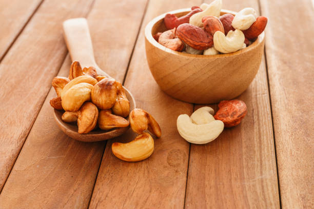 istock Cashew nuts in a wood spoon and cup .. 1472297566