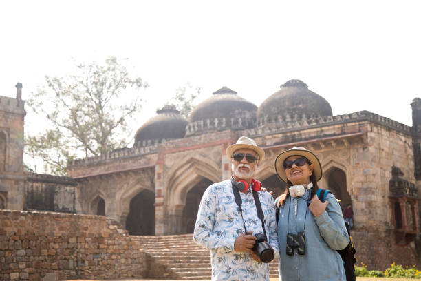 istock Old couple tourist looking up at ancient architecture 1472297773