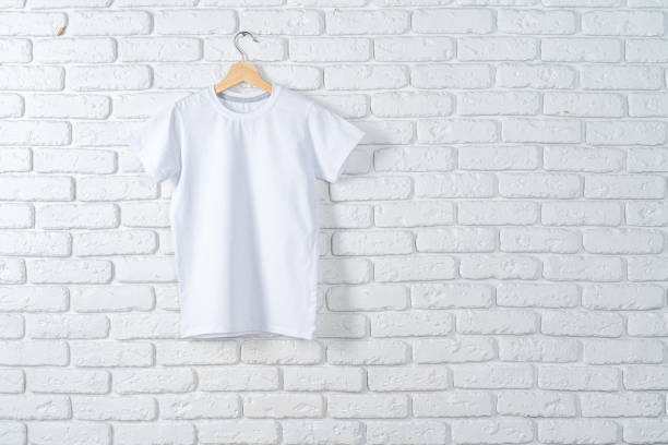 istock White t-shirt hanging on hanger against brick wall 1472298712