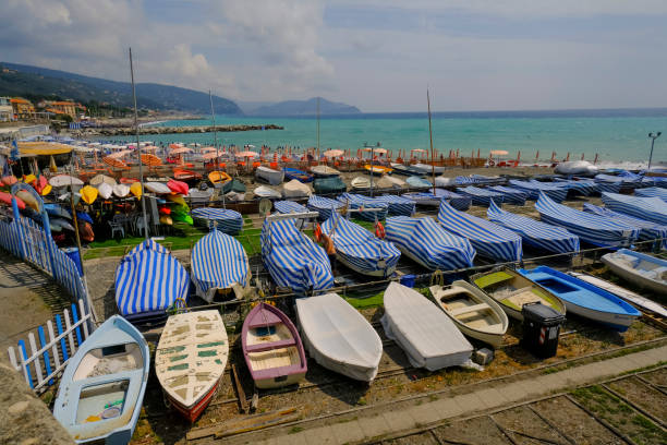 many colorful boats on the shore across the seaside view in Lavagna, Liguria, Italy. Coast view many colorful boats on the shore across the seaside view in Lavagna, Liguria, Italy. Coast view lavagna stock pictures, royalty-free photos & images