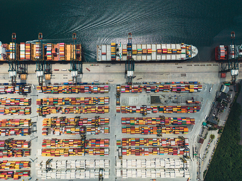 Aerial view of cargo ship, cargo container in warehouse harbor.