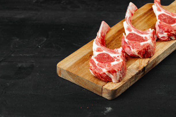 istock Racks of lamb ready for cooking on dark background 1472300823