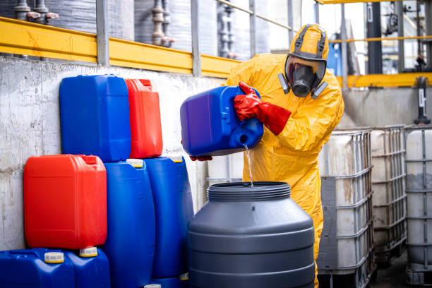 istock Professional chemicals industry worker in protective equipment making acids for zinc galvanizing. 1472300973