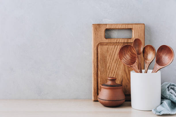 istock Kitchen utensils background. Wooden spoons and cutting board on light background with copy space. 1472302481