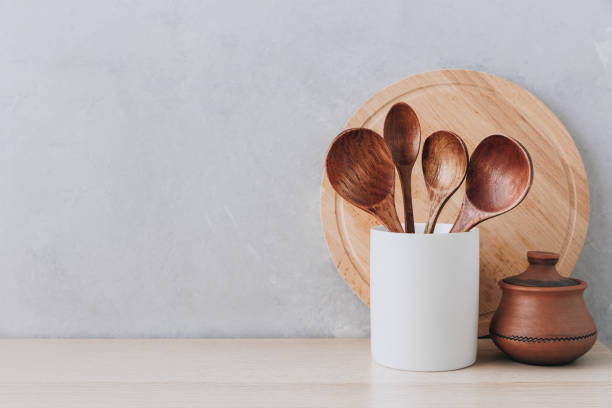 istock Kitchen utensils background. Wooden spoons and cutting board on light background with copy space. 1472302497