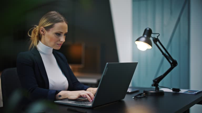 SLO MO Stylish businesswoman works late on her laptop in the office