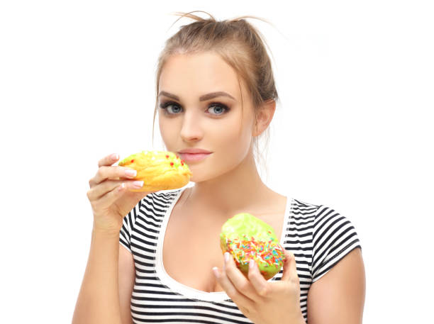 istock Funny girl  and colorful donuts. 1472305242