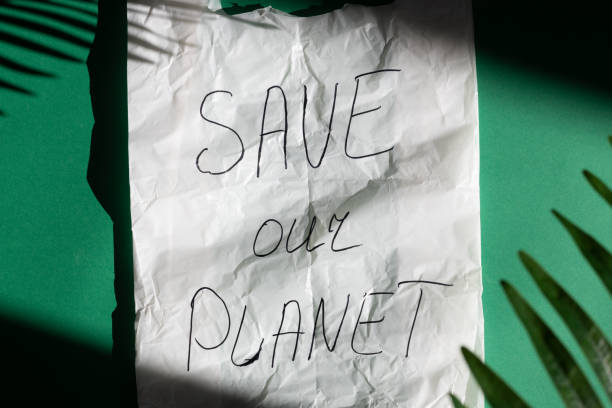 istock Plastic bag and the inscription - save our planet on a green background. 1472305324