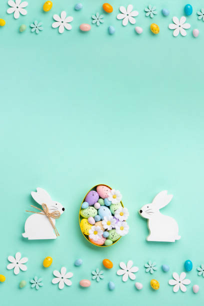 istock Easter Eggs with Sweets and Spring Flowers on Blue Background 1472305789