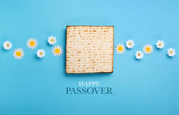 Passover Greeting Card with Matzah, Nuts and Spring Flowers on Blue Background.
