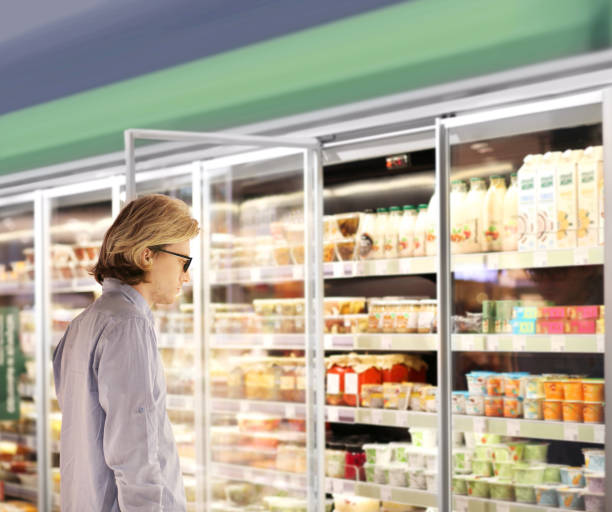 istock man choosing a dairy products at supermarket 1472307244