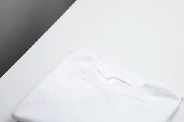istock Basic folded white t-shirt. Mock up for branding t-shirt. Copy space 1472307363