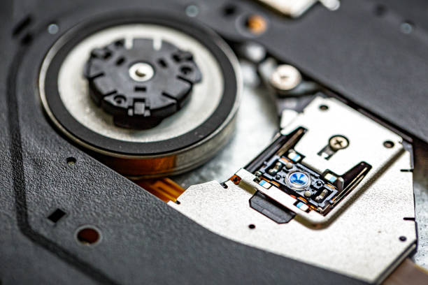 Macro close up depicting the inside of a CD/DVD disc drive on a laptop.