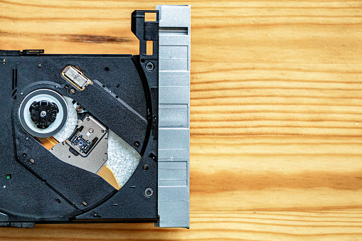 Macro close up depicting the inside of a CD/DVD disc drive on a laptop.