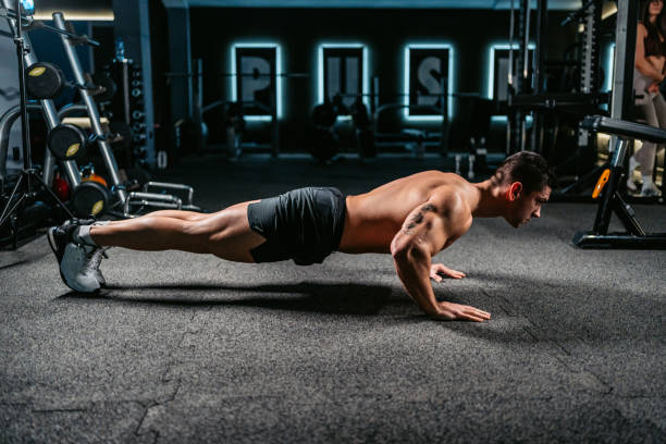 istock Young Man Doing Push-Ups At The Gym 1472311689