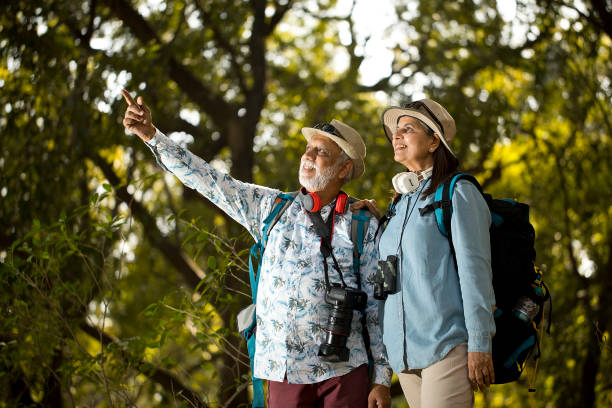 istock Senior couple having fun exploring at forest 1472311917