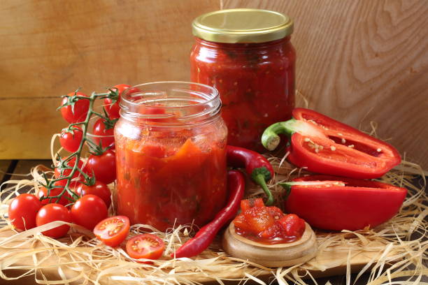 istock Lecho in glass jars on a wooden table 1472312090